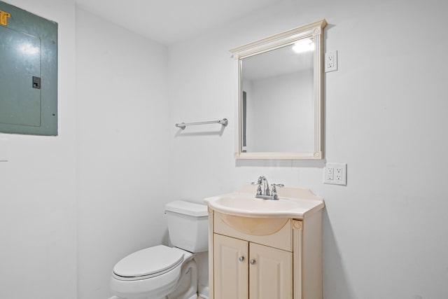 bathroom featuring vanity, toilet, and electric panel