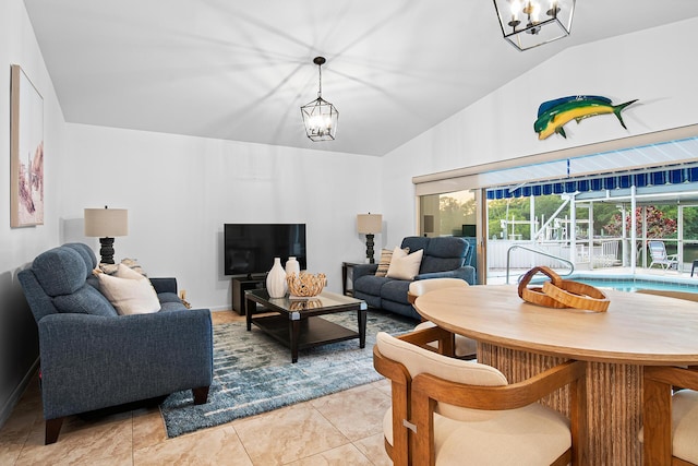 living room with light tile patterned flooring, vaulted ceiling, and a notable chandelier