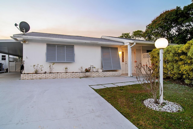 ranch-style home featuring a carport