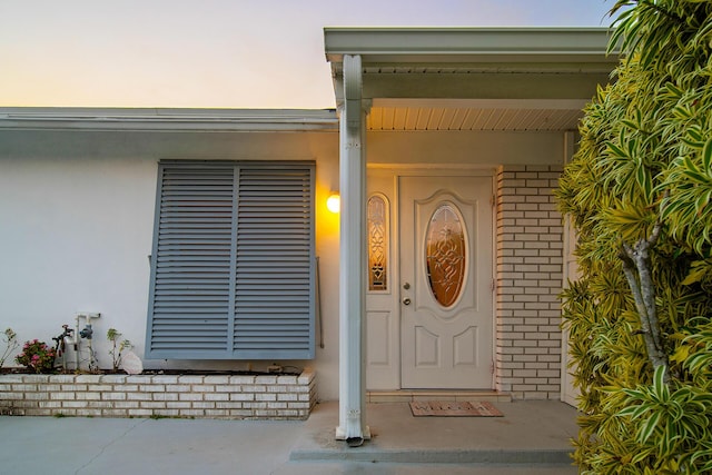 view of exterior entry at dusk