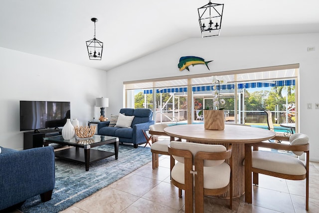 tiled dining area with an inviting chandelier, a healthy amount of sunlight, and lofted ceiling