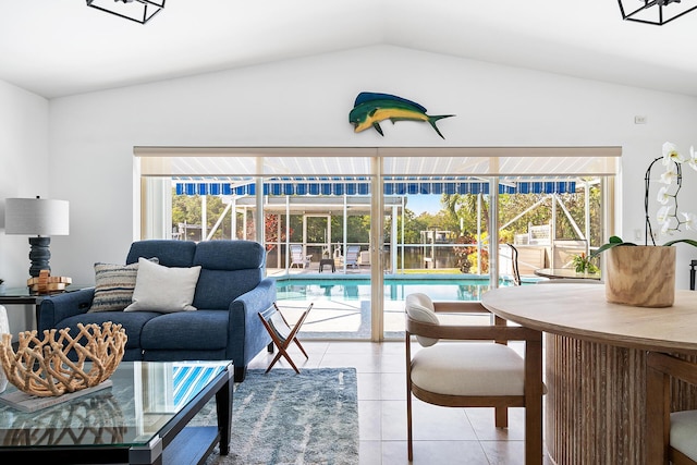 tiled living room with lofted ceiling and a wealth of natural light