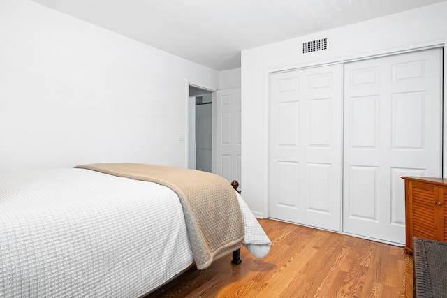 bedroom featuring a closet and light wood-type flooring