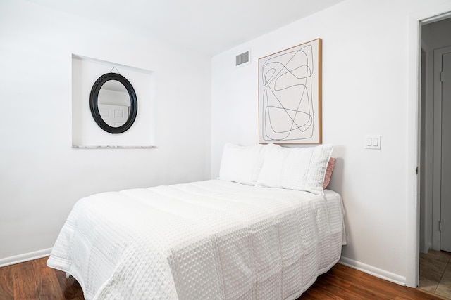 bedroom featuring dark hardwood / wood-style flooring