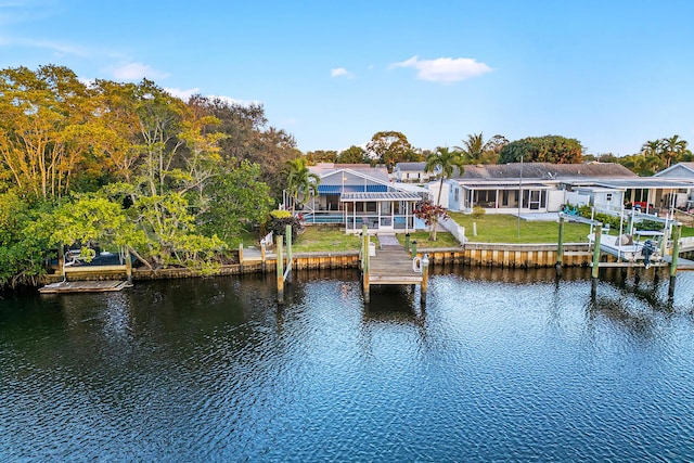 view of dock featuring a water view and a yard