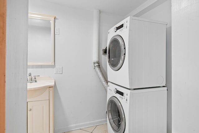 washroom with stacked washer and clothes dryer, sink, and light tile patterned floors