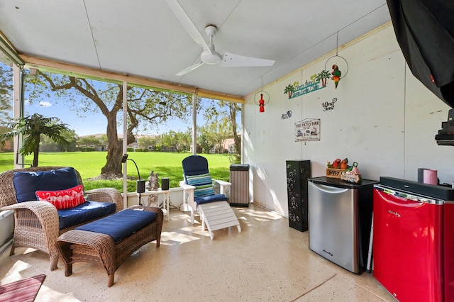 sunroom featuring a ceiling fan and plenty of natural light