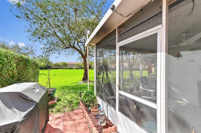 exterior space with a sunroom and a grill