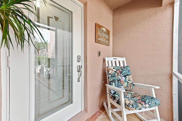 doorway to property with stucco siding