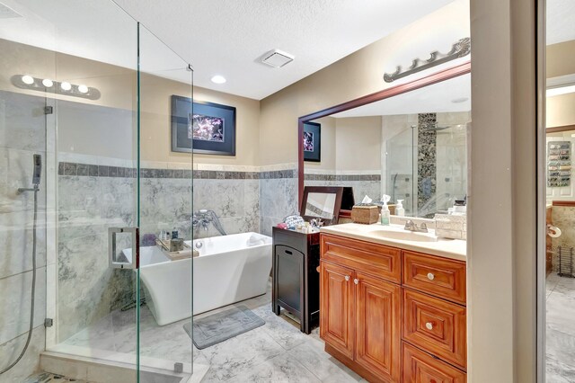 1075 E Lancewood Pl, Delray Beach, FL 33445 - full bath with a freestanding tub, vanity, a shower stall, and tile walls