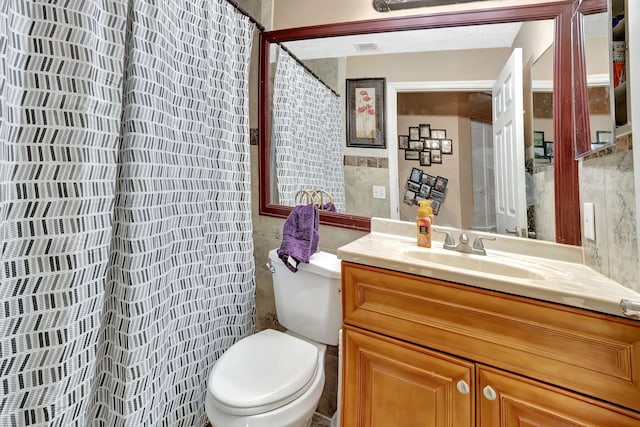 1075 E Lancewood Pl, Delray Beach, FL 33445 - bathroom with tile walls, toilet, vanity, and curtained shower