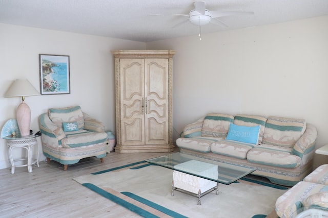 living room with ceiling fan and wood finished floors