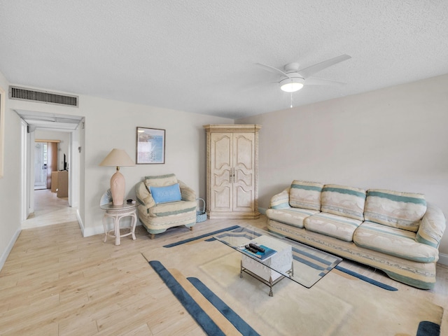 12 Valencia Unit A, Delray Beach, FL 33446 - living area with a ceiling fan, a textured ceiling, visible vents, baseboards, and light wood finished floors
