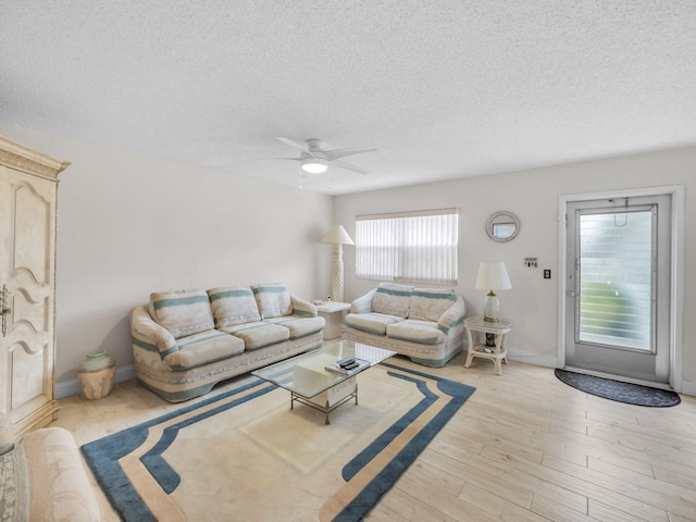 12 Valencia Unit A, Delray Beach, FL 33446 - living room featuring baseboards, a textured ceiling, ceiling fan, and wood finished floors