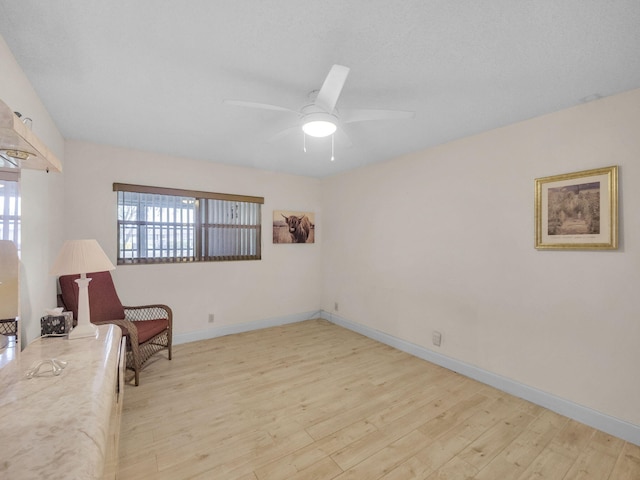 12 Valencia Unit A, Delray Beach, FL 33446 - sitting room with baseboards, ceiling fan, and light wood-type flooring