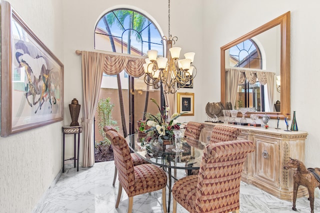 6525 Via Benita, Boca Raton, FL 33433 - dining room featuring marble finish floor, a high ceiling, and an inviting chandelier