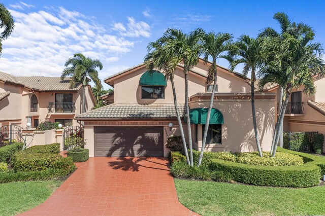 6525 Via Benita, Boca Raton, FL 33433 - mediterranean / spanish home featuring a tiled roof, decorative driveway, a garage, and stucco siding