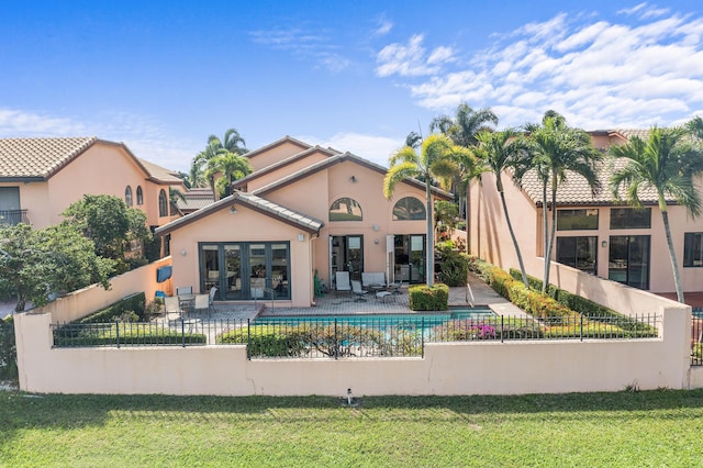 6525 Via Benita, Boca Raton, FL 33433 - back of house featuring a yard, stucco siding, fence private yard, and a patio