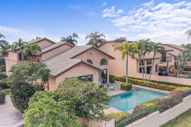 6525 Via Benita, Boca Raton, FL 33433 - back of property with stucco siding, a tile roof, a patio, fence, and a fenced in pool