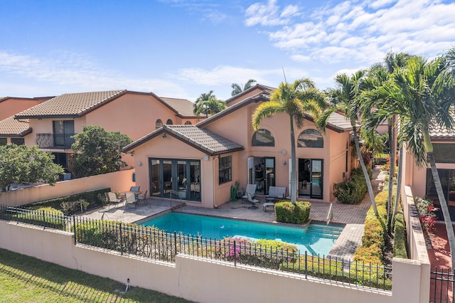 6525 Via Benita, Boca Raton, FL 33433 - back of house with a fenced in pool, fence, a tiled roof, stucco siding, and a patio area