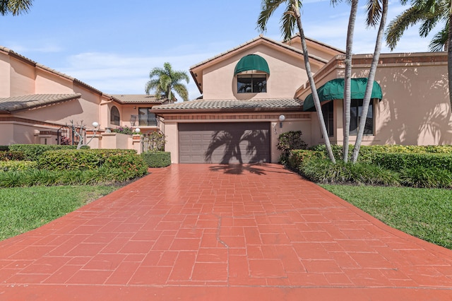 6525 Via Benita, Boca Raton, FL 33433 - view of front of house featuring stucco siding, a tile roof, and decorative driveway
