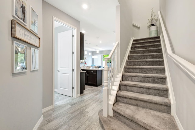 stairway with hardwood / wood-style floors