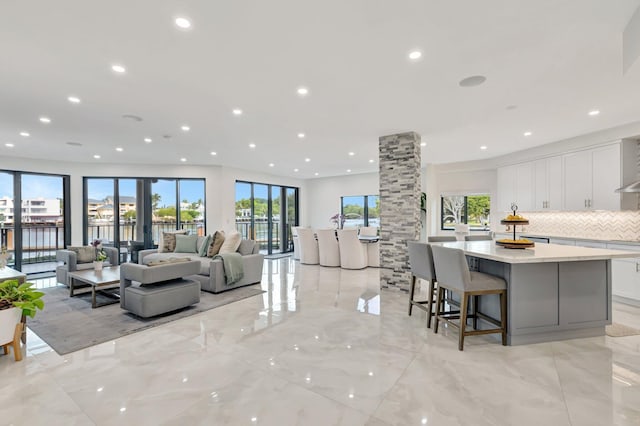 800 Andrews Ave Unit 9, Delray Beach, FL 33483 - interior space with recessed lighting, marble finish floor, a spacious island, white cabinetry, and decorative backsplash