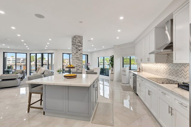 800 Andrews Ave Unit 9, Delray Beach, FL 33483 - kitchen featuring a sink, wall chimney range hood, a center island, and recessed lighting