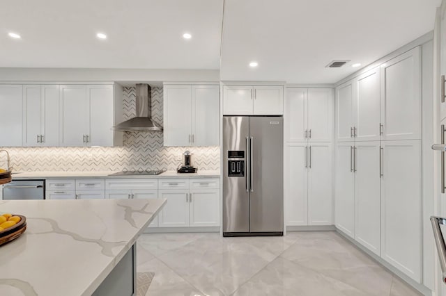 800 Andrews Ave Unit 9, Delray Beach, FL 33483 - kitchen featuring wall chimney range hood, appliances with stainless steel finishes, visible vents, and white cabinetry