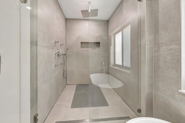 800 Andrews Ave Unit 9, Delray Beach, FL 33483 - full bath featuring tile patterned flooring, tile walls, and a shower stall