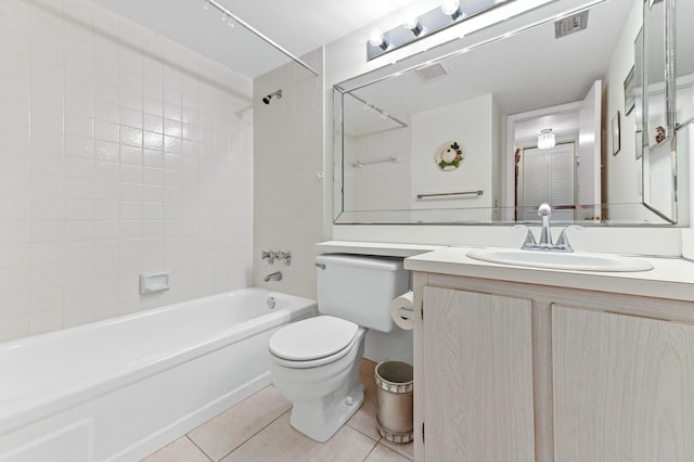 full bathroom featuring tile patterned flooring, tiled shower / bath, vanity, and toilet