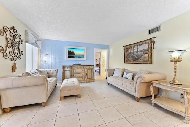 living room with light tile patterned floors and a textured ceiling