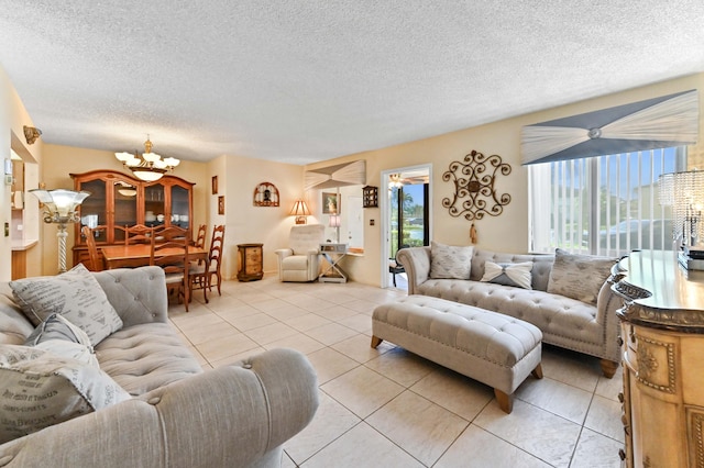 tiled living room featuring a chandelier and a textured ceiling