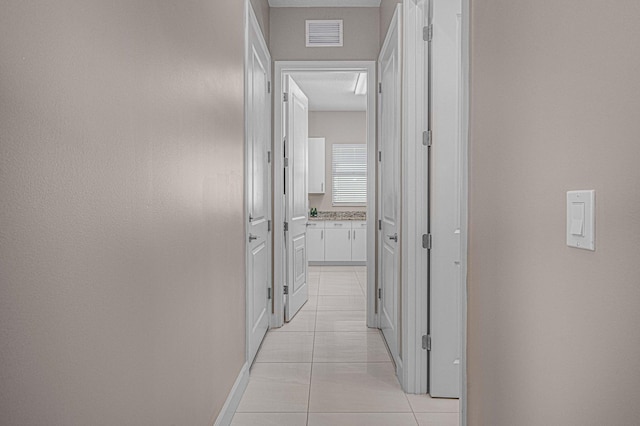 hall featuring light tile patterned flooring