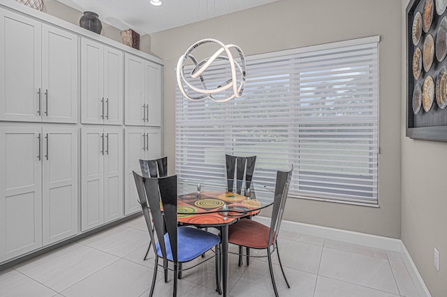 dining room with a notable chandelier and light tile patterned floors