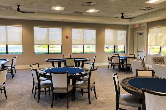 carpeted dining room with plenty of natural light, a drop ceiling, and ceiling fan