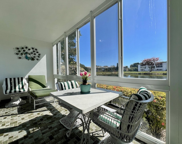 sunroom / solarium with a wealth of natural light and a water view