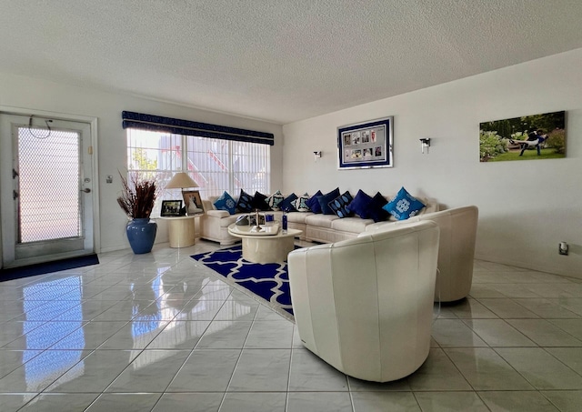 tiled living room featuring a textured ceiling