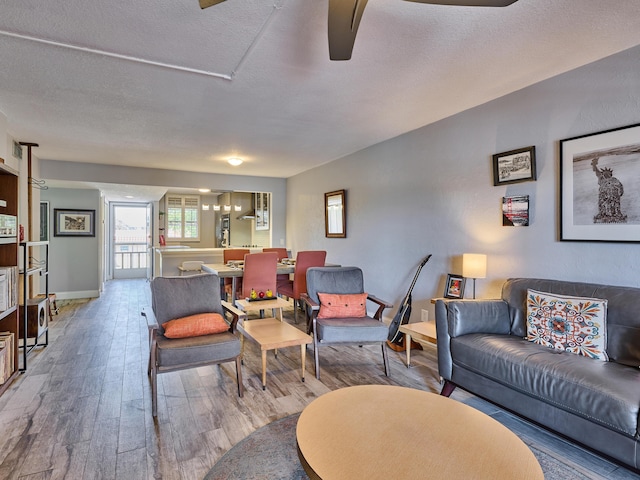 living room featuring wood-type flooring and a textured ceiling