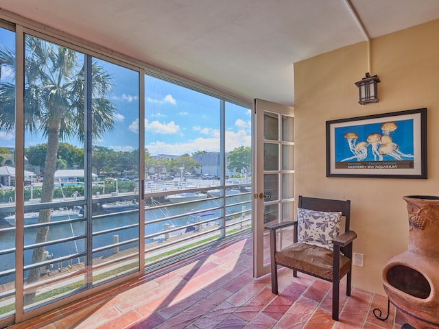 sunroom / solarium with a water view