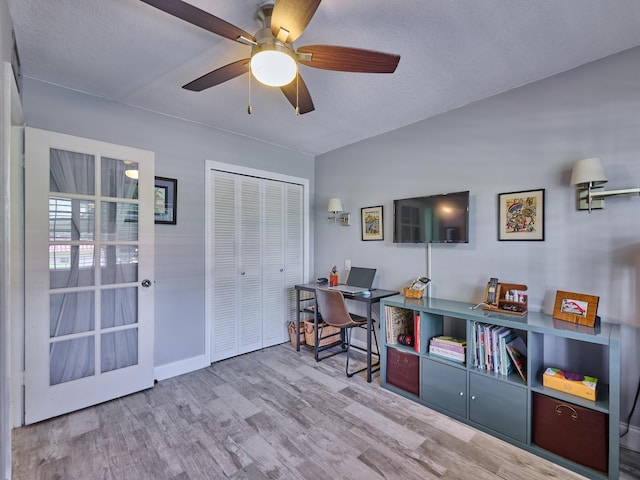 office space with hardwood / wood-style flooring, ceiling fan, and a textured ceiling