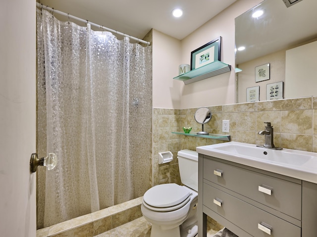 bathroom featuring vanity, tile walls, walk in shower, and toilet