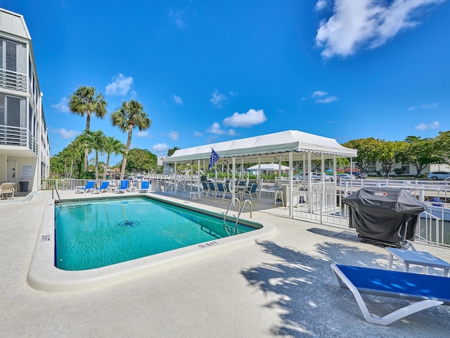 view of swimming pool with area for grilling and a patio