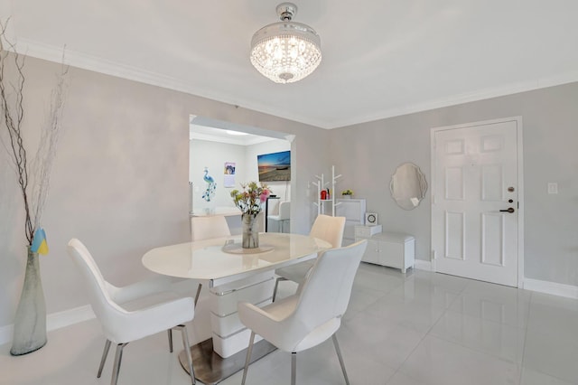 dining area featuring an inviting chandelier and ornamental molding