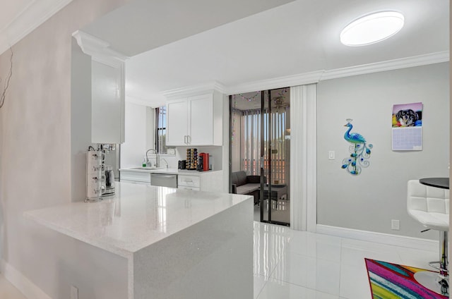 kitchen with sink, light stone counters, stainless steel dishwasher, ornamental molding, and white cabinets