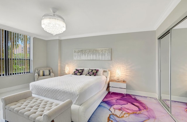 bedroom with ornamental molding, a closet, and a chandelier