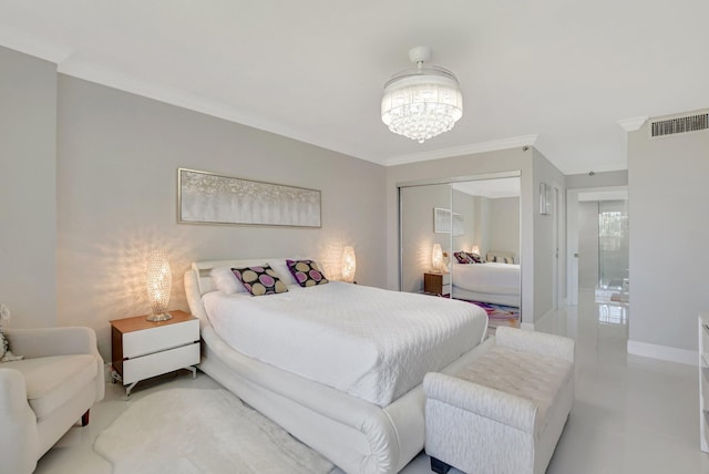 bedroom with ornamental molding, a chandelier, and a closet