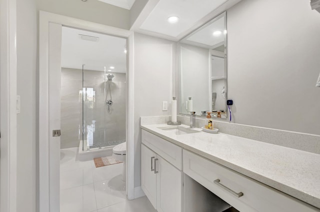 bathroom with vanity, toilet, and a shower with shower door