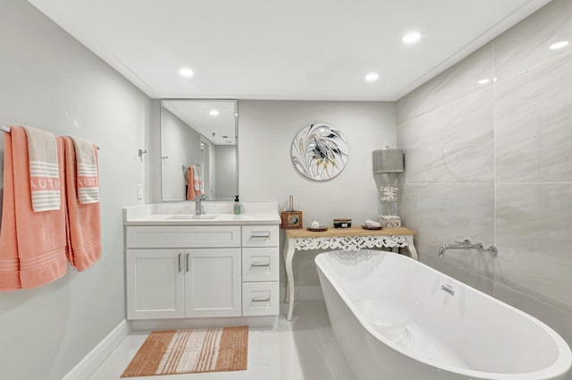 bathroom with vanity, a tub to relax in, and tile patterned flooring