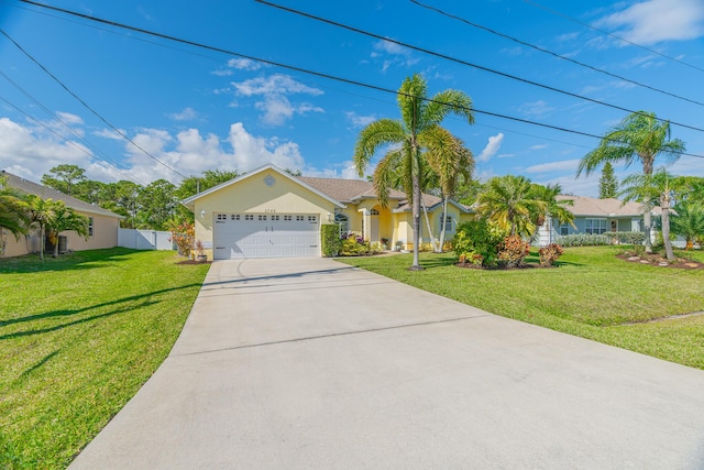 ranch-style house with a front yard, concrete driveway, an attached garage, and fence